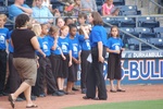 Shebly (far right) and her chorus get ready for the National Anthem